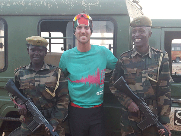 It's all smiles as John meets some well-armed members of the military on one of his runs.