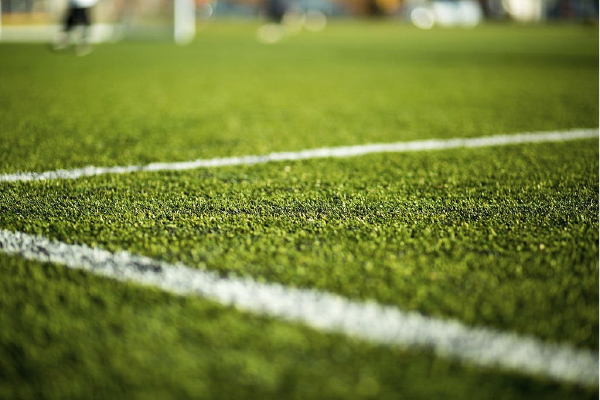 Why is an artificial turf for a football field a good idea?